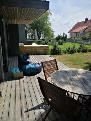 Cozy 1-bedroom lagoon apartment with free parking space in Pervalka